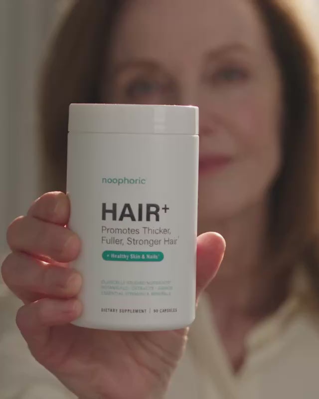 Noophoric Hair+ bottle held in a daily routine